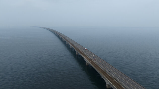 infinite bridge running into the water, highway mobility infrastructure. Aerial photo