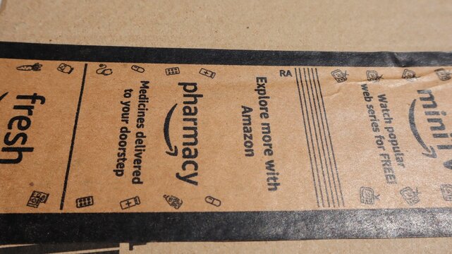 Amazon delivery parcel brown box. Amazon labeled with mini tv, fresh, pharmacy