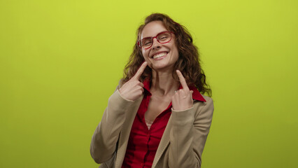 Woman pointing at her smile with glasses over a bright yellow background exuding joy and confidence.