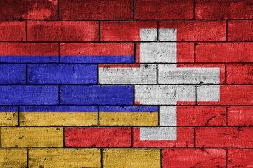 colourful painted big national flag of switzerland and flag of armenia on a massive old brick wall background. concept