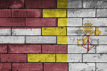 colourful painted big national flag of vatican city and flag of latvia on a massive old brick wall background. concept