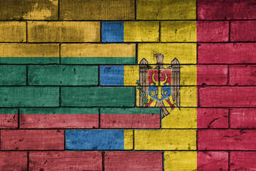 colourful painted big national flag of moldova and flag of lithuania on a massive old brick wall background. concept