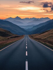 Fototapeta premium Lake District Panorama Photo with Road stretching out into the Distance. Beautiful Mountain Scene at Sunset.