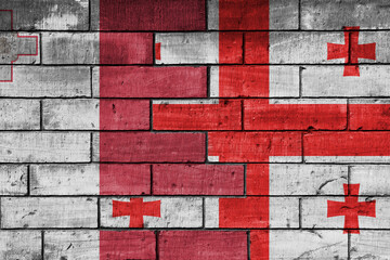 colourful painted big national flag of georgia and flag of malta on a massive old brick wall background. concept