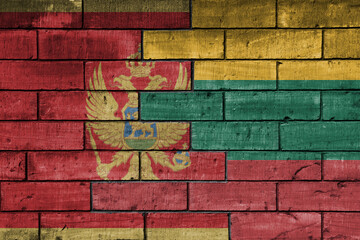 colourful painted big national flag of lithuania and flag of montenegro on a massive old brick wall background. concept