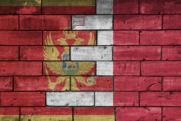 colourful painted big national flag of malta and flag of montenegro on a massive old brick wall background. concept