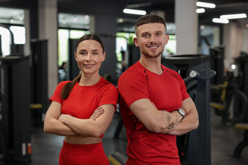Portrait of professional personal trainers in gym