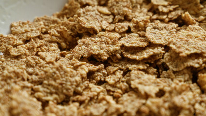 Close-up image of crispy corn flakes cereal, ideal for breakfast or healthy eating representations.