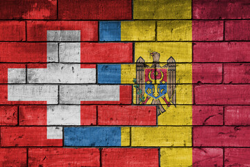 colourful painted big national flag of moldova and flag of switzerland on a massive old brick wall background. concept