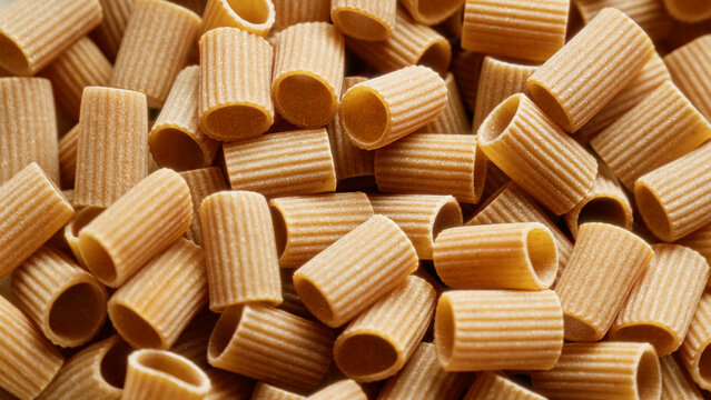 Closeup of wholegrain pasta tubes showcasing detailed texture and natural color