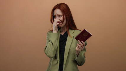 Woman holding chinese passport reacts to unpleasant smell with a disgusted expression against a...