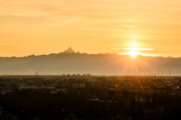 Incredible sunset over Turin city (Torino) with snowy Alps mountains on background. Piedmont, Italy