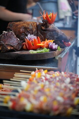 Roasted pork garnished with various fruits and vegetables