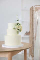 Delicious wedding cake with floral decor on wooden table indoors