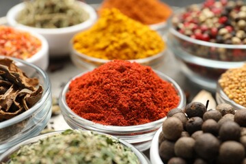 Different aromatic spices in bowls on table, closeup