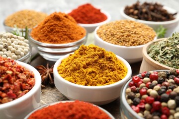 Different aromatic spices in bowls on table, closeup