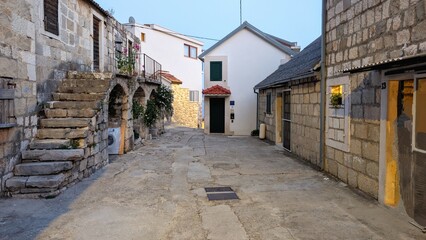 Quiet Mediterranean village lane with historic stone homes, Mimice, Dalmatian Coast, Croatia