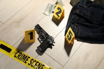 Forensic expertise. Crime scene with evidence, markers and police tape on floor