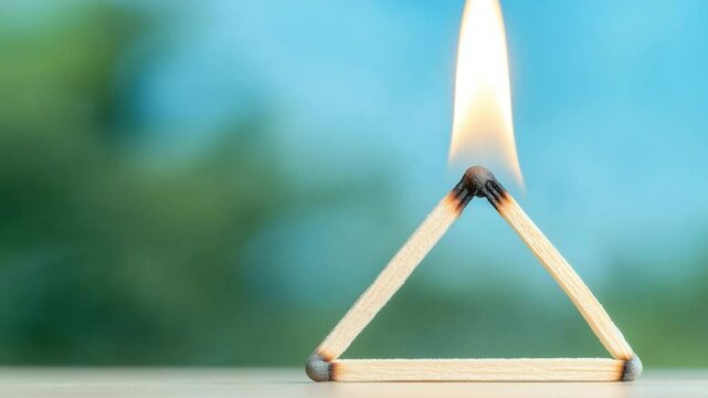 Fiery Triangle: Capturing the moment a triangle is being formed by three matches being lit, symbolizing a fiery formation of the new idea with blurred background 