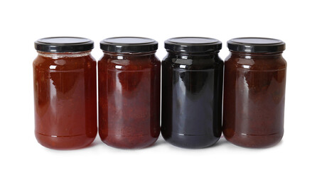 Different sweet jams in jars isolated on white