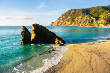 Coastal village Monterosso al Mare glows under summer sun in Cinque Terre National Park, Liguria, Italy. Ligurian sea in summer time. Landscape photography