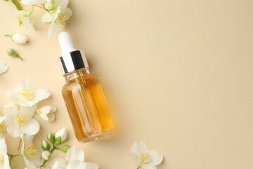 Naklejka na ściany i meble Essential oil and beautiful jasmine flowers on beige background, flat lay. Space for text