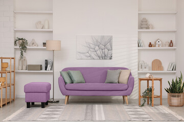 Stylish living room with comfortable sofa and light wall. Interior design