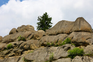 Massive stone rocks with weathered surfaces and protrusions create a majestic, unique relief,...