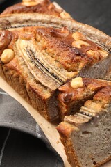 Cut banana bread with nuts on table, closeup