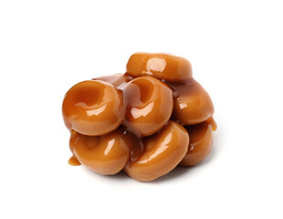 Tasty sweet candies and caramel sauce isolated on white