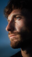 A Thoughtful Young Man Gazing Into Distance in Soft Evening Light