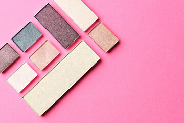 Beautiful eyeshadow refill pans on pink background, flat lay. Space for text