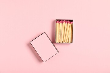 Matches and box on pink background, flat lay. Mockup for design