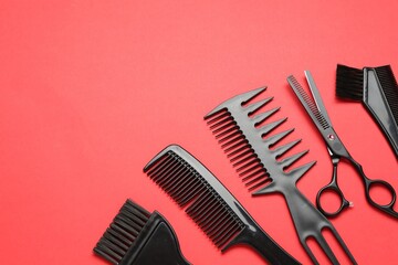 Different hairdresser's tools on red background, above view. Space for text