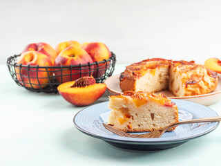 Piece of nectarine peach cake on turquoise table