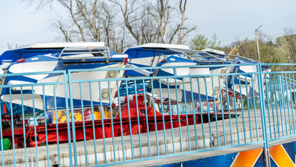 Amusement park ride awaits visitors on a sunny day near the entrance, providing thrilling experiences for all ages