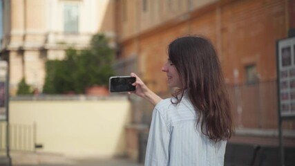 Young woman taking a selfie on a city street - Powered by Adobe