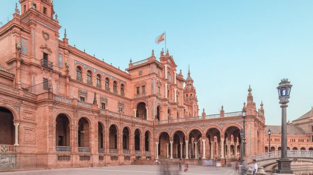 Plaza de Espana in Seville timelapse hyperlapse, a grand architectural complex in Maria Luisa Park built for the Ibero-American Exposition. Bridges and vintage streetlights during sunset