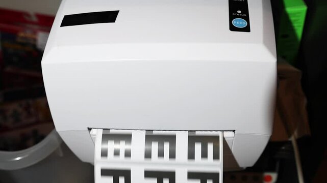 Man hand tear off sticker label with note fragile at thermal printer