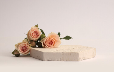 Stones platform podium, beige cream Rose flower bouquet on white background. Minimal empty pedestal...