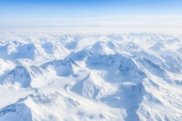 Obraz premium An aerial perspective captures vast mountainous landscapes adorned with glaciation, highlighting stunning snow-covered peaks and serene valleys