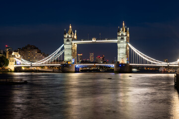 Tower bridge in London England at night over Thames river