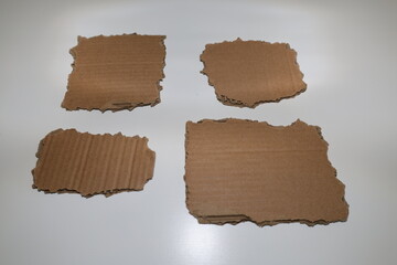Small cartboard pieces of cardboard with torn edges