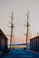 Oslo harbour with Stiftelsen Christian Radich and Skur 32 at dusk transforms into a mesmerising scene, with long-exposure capturing the vibrant night lights reflecting on the calm water