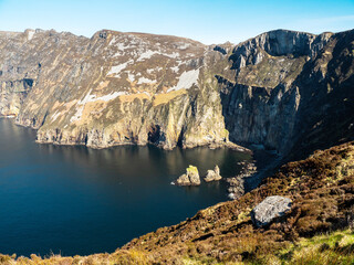 Obraz premium Stunning nature scenery of Slieve League area with tall cliff and ocean, county Donegal, Ireland. Popular tourist area. Warm sunny day with blue sky.