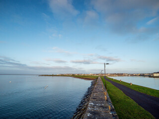 Fototapeta premium View from Nimmos Pier at high tide, Galway bay on the left and river Corrib on the right. West of Ireland. Popular tourist area with amazing view.