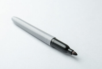 One black marker on light background, closeup. Space for text