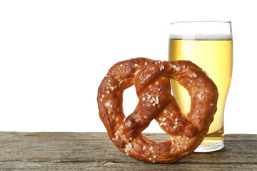 Tasty pretzel and glass of beer on wooden table against white background. Space for text