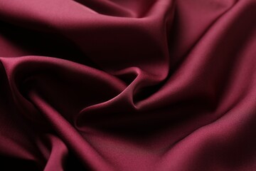 Crumpled burgundy silk fabric as background, closeup