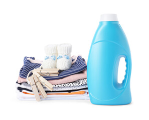 Bottle with fabric softener, shoes, baby clothes and clothespins isolated on white